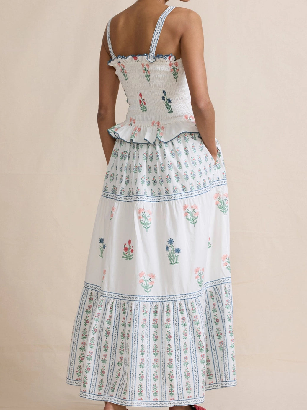 Woman wearing a floral dress with a beige background